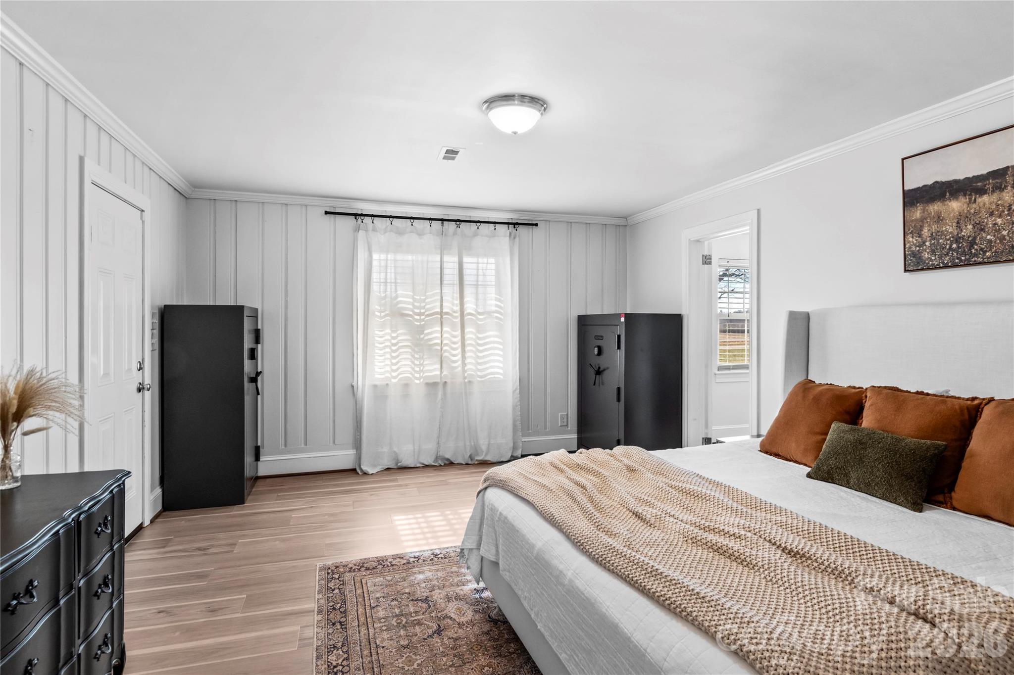 2432 Holcomb Road Yadkinville, NC 27055 - Photo 20 of 37 a bedroom with a large bed and wooden floor