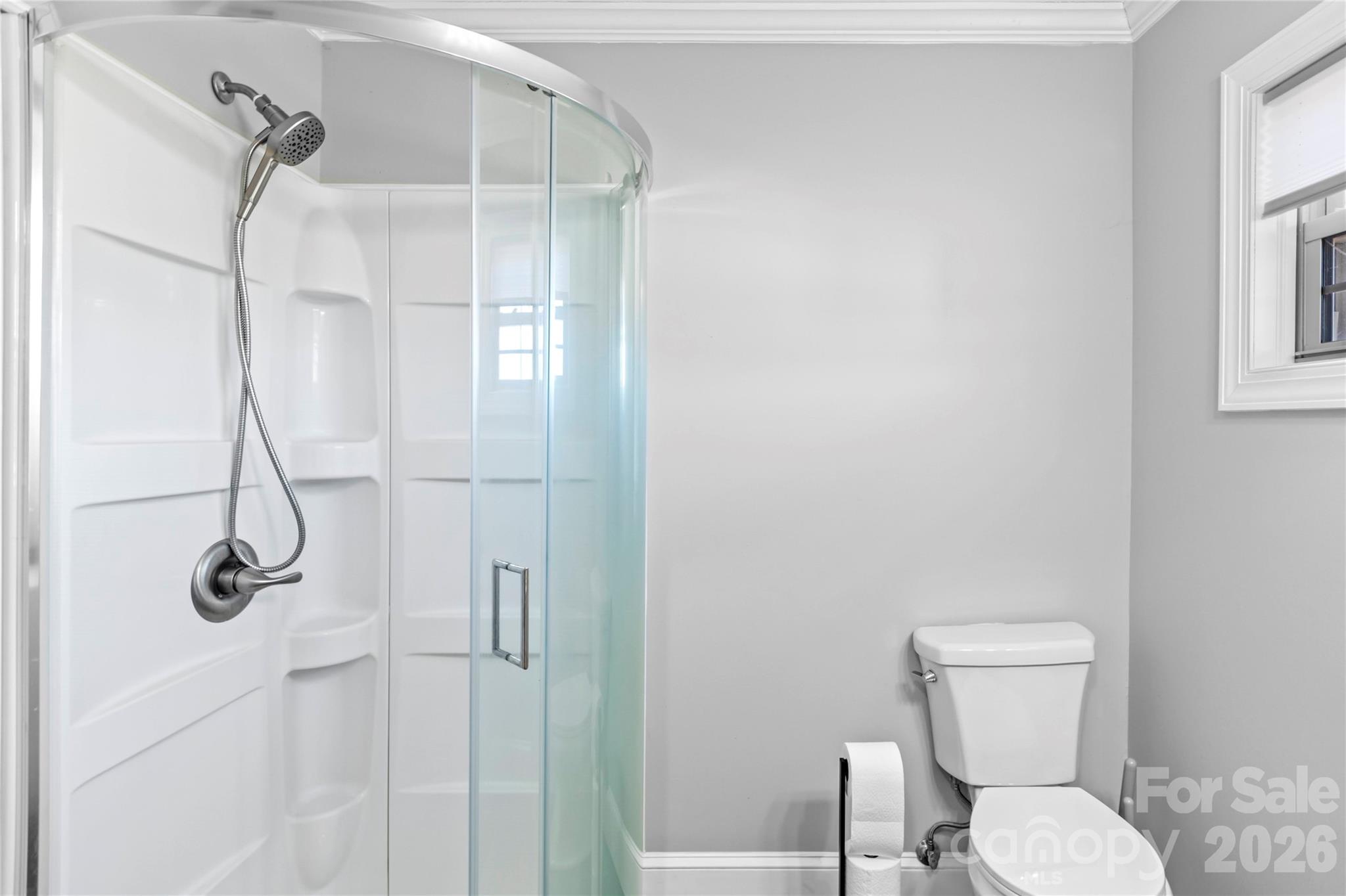 2432 Holcomb Road Yadkinville, NC 27055 - Photo 21 of 37 a bathroom with a toilet and a shower