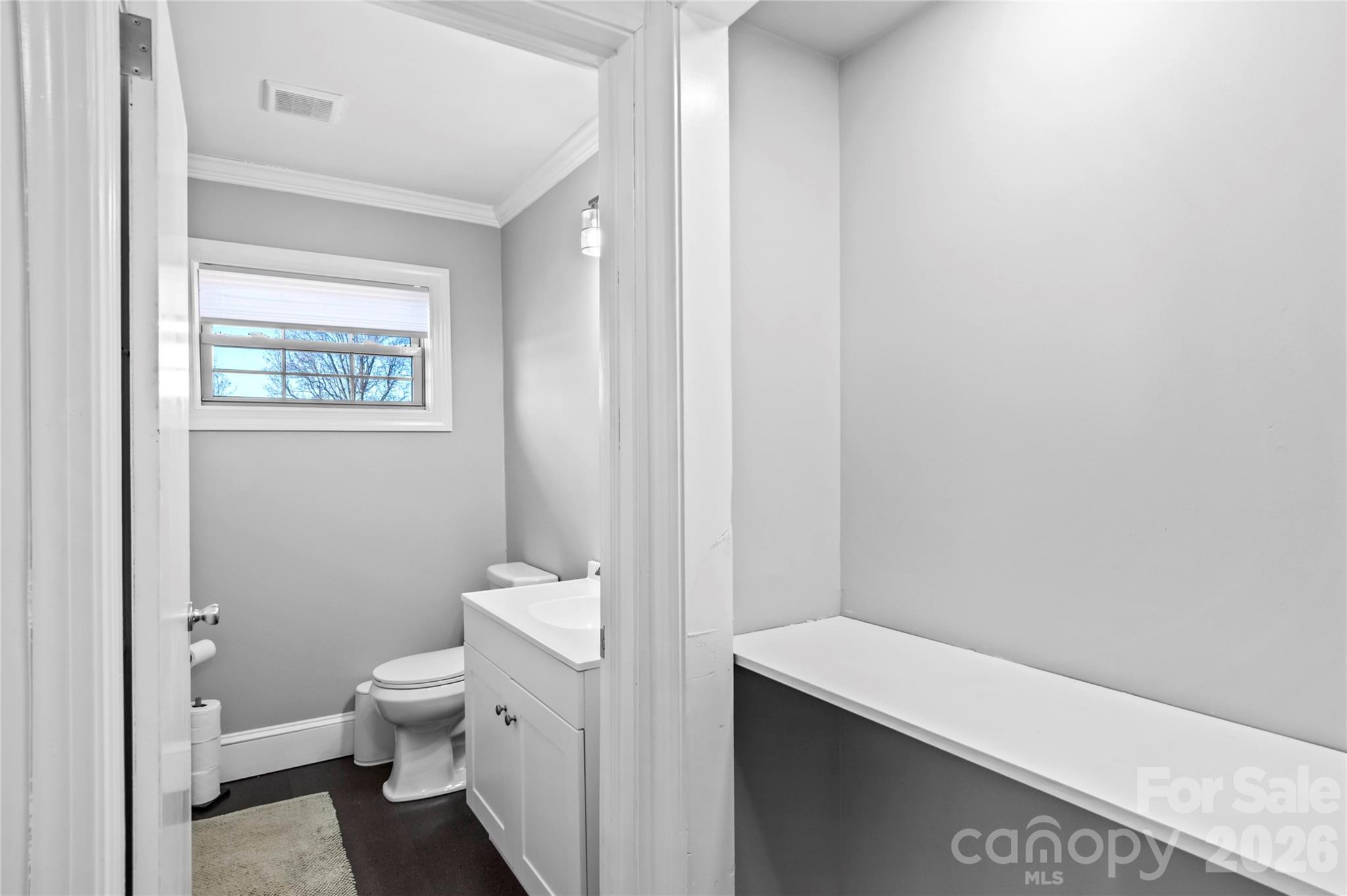 2432 Holcomb Road Yadkinville, NC 27055 - Photo 25 of 37 a bathroom with a toilet a sink and a window