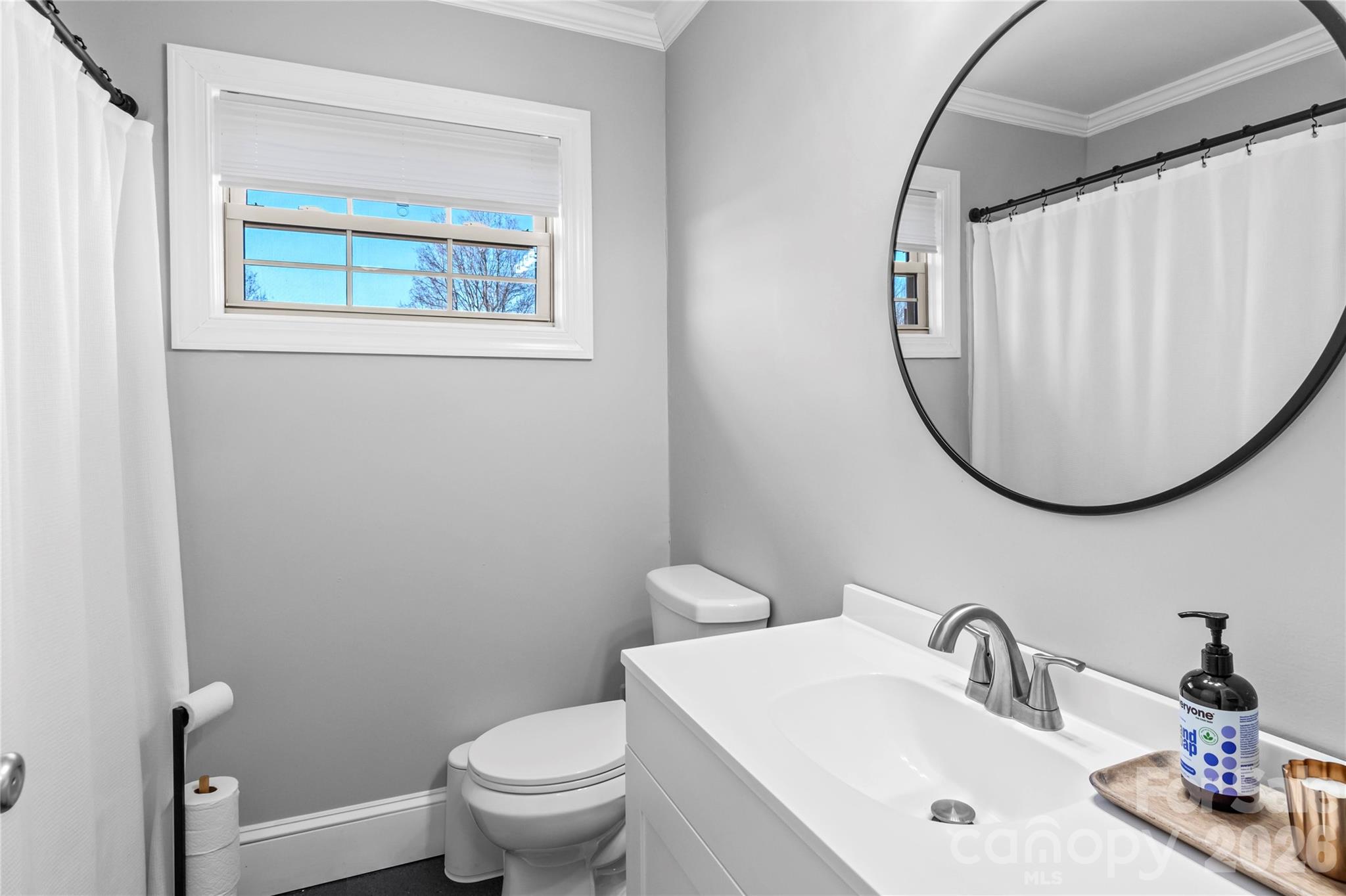 2432 Holcomb Road Yadkinville, NC 27055 - Photo 26 of 37 a bathroom with a sink mirror and toilet