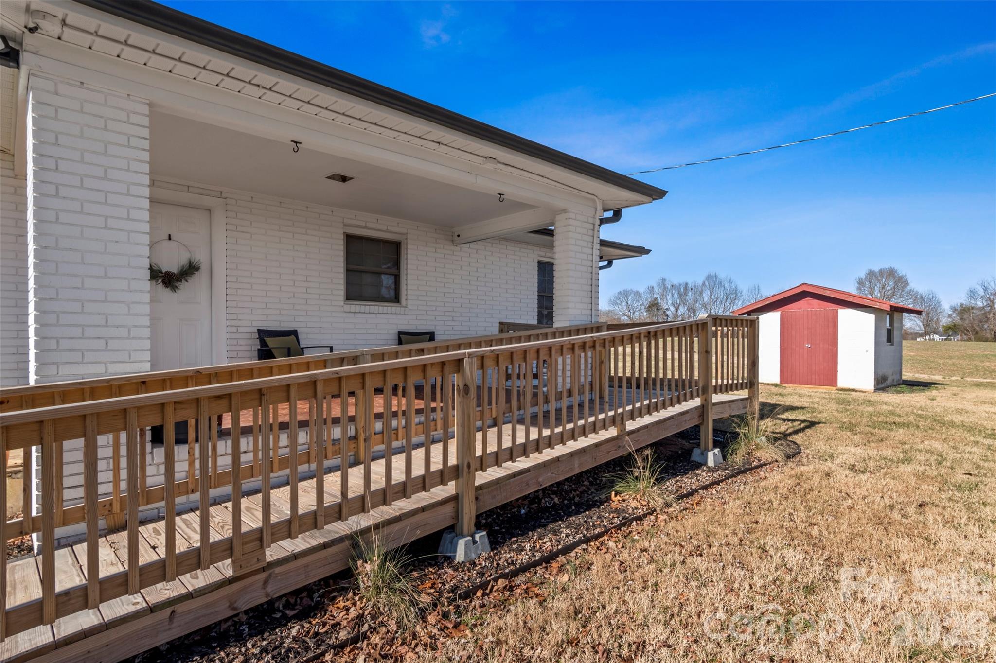 2432 Holcomb Road Yadkinville, NC 27055 - Photo 32 of 37 a balcony with wooden floor and fence