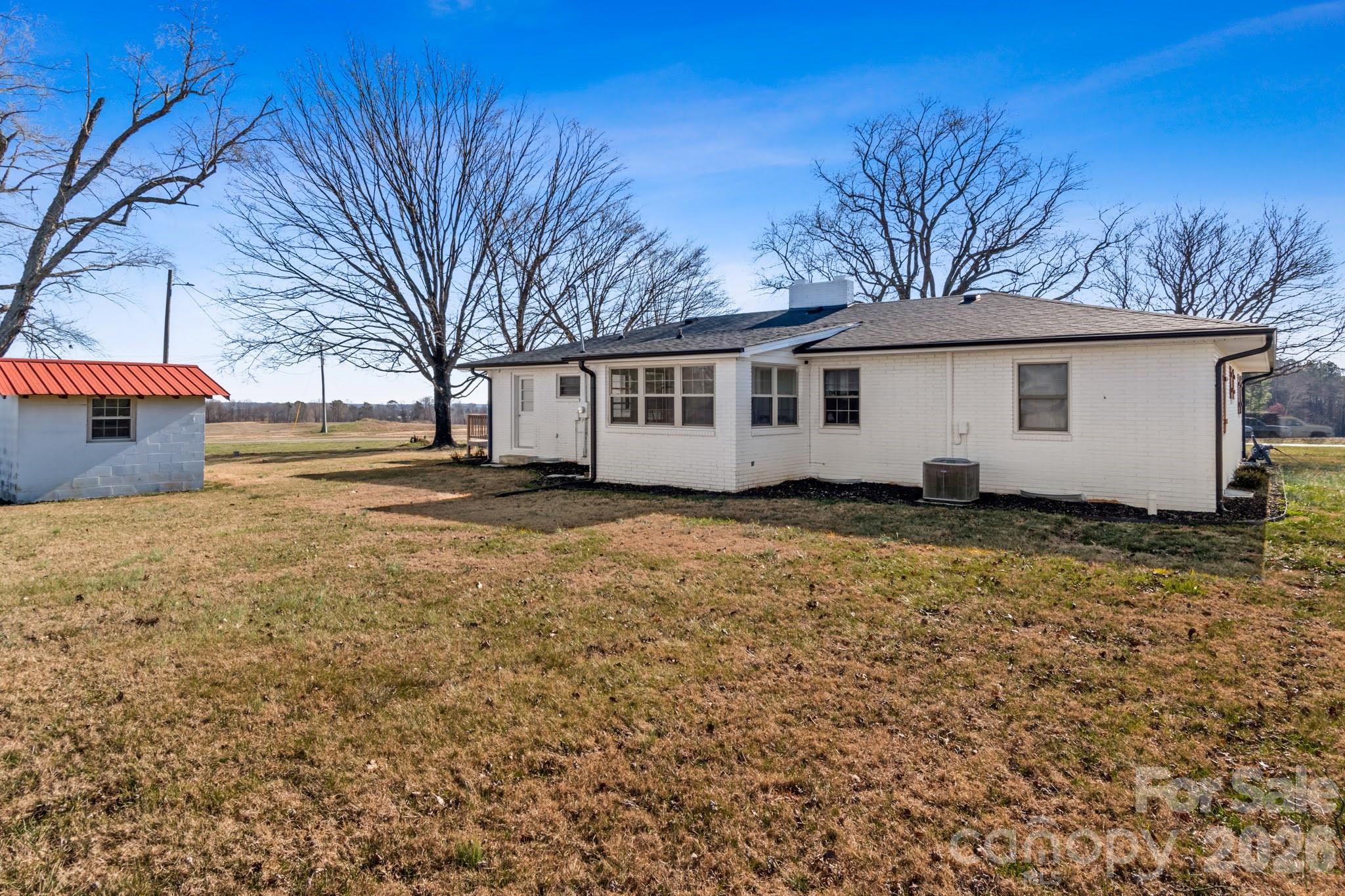 2432 Holcomb Road Yadkinville, NC 27055 - Photo 34 of 37 a view of a house with a yard