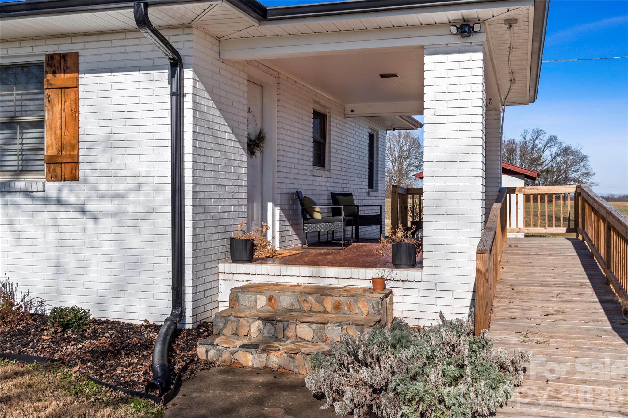 2432 Holcomb Road Yadkinville, NC 27055 - Photo 5 of 37 a view of a patio with table and chairs and potted plants