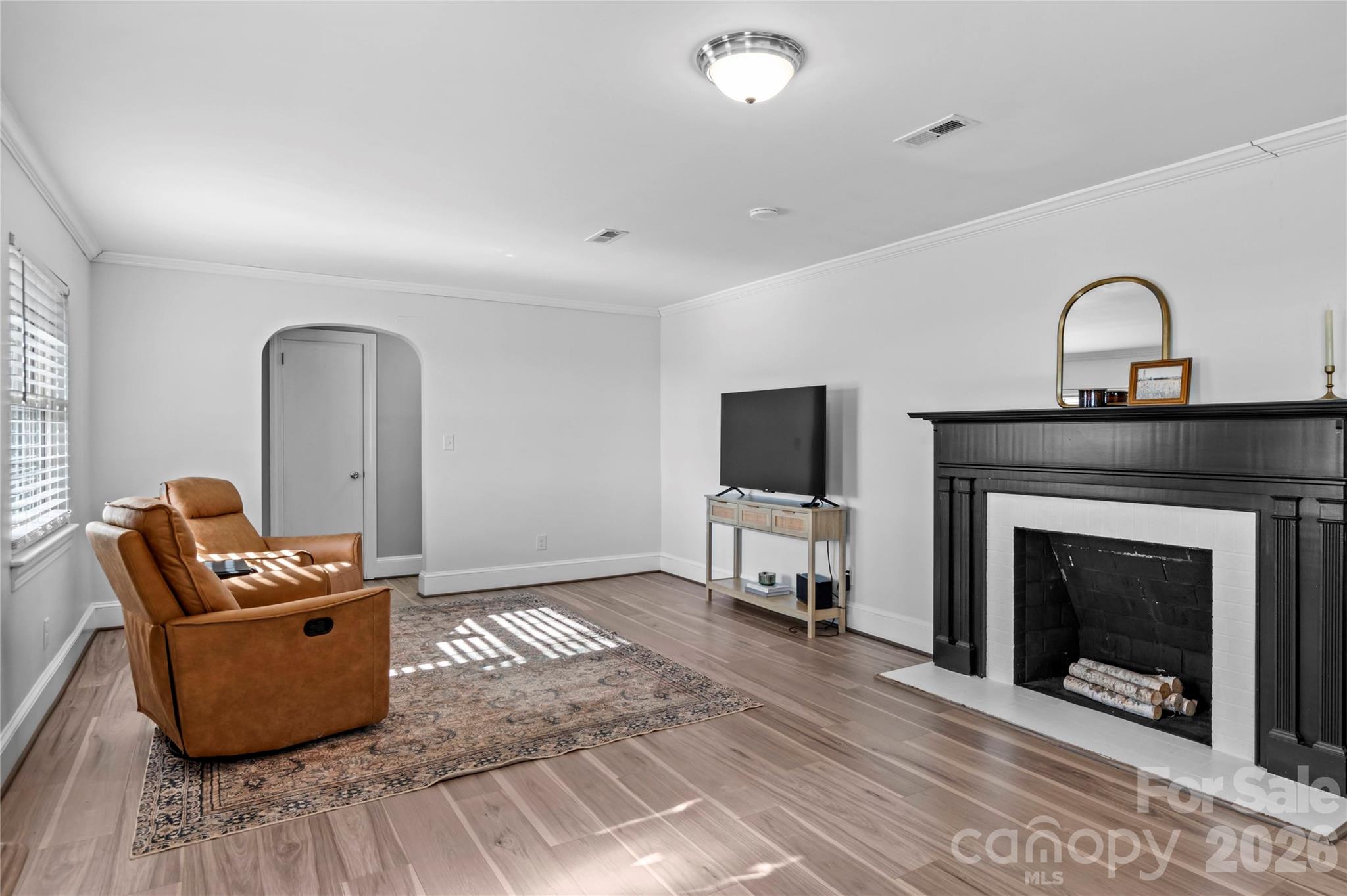 2432 Holcomb Road Yadkinville, NC 27055 - Photo 8 of 37 a living room with furniture a fireplace and a flat screen tv