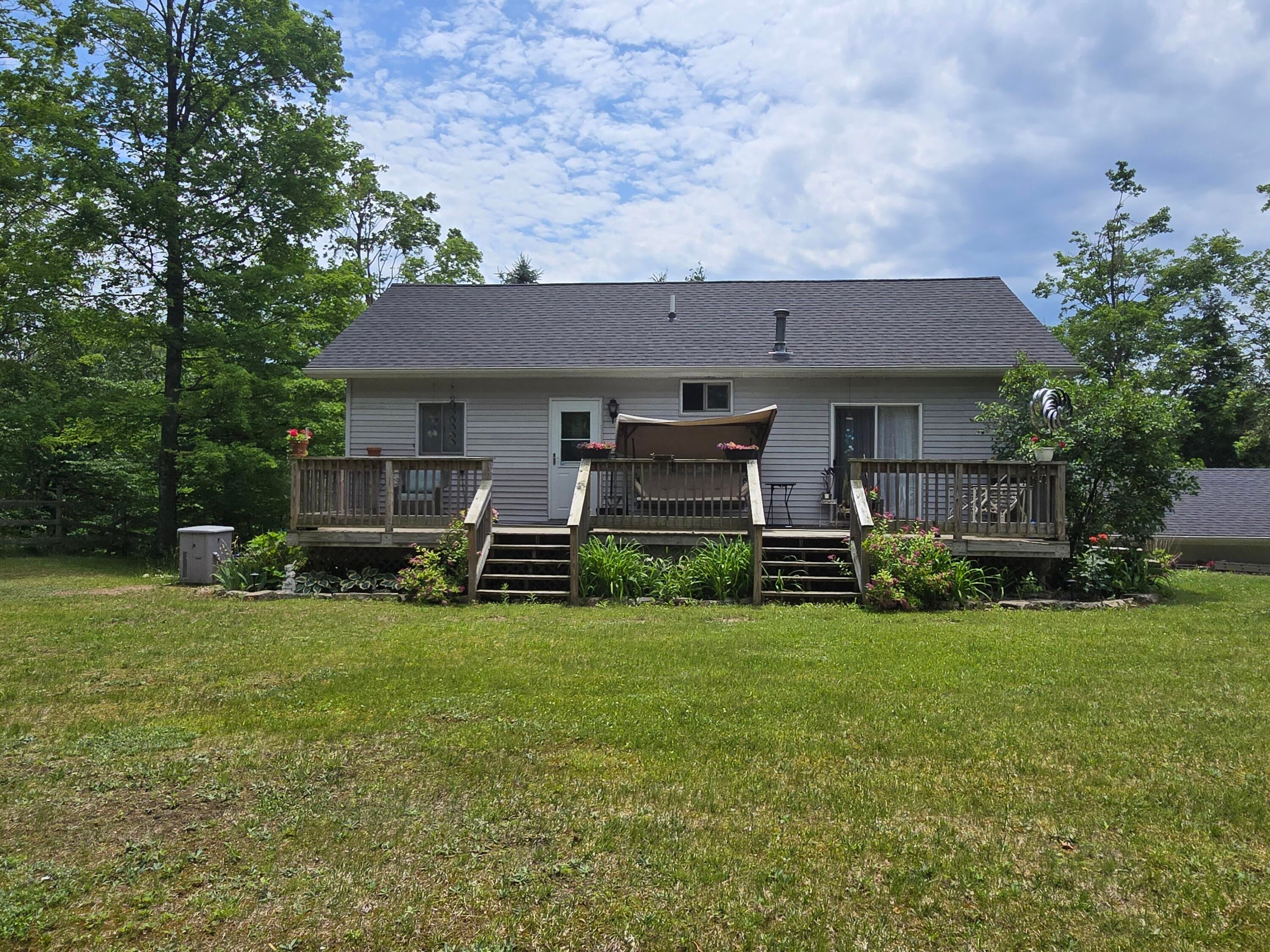 5500 Oley Lake Road Gaylord, MI 49735 - Photo 4 of 44 Backyard view 2025