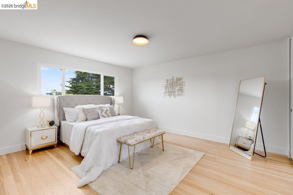 1298 Ribbon Street Foster City, CA 94404 - Photo 58 of 86 Bright bedroom featuring expansive windows, light wood-finish flooring, a contemporary flush-mount ceiling light, and white painted walls