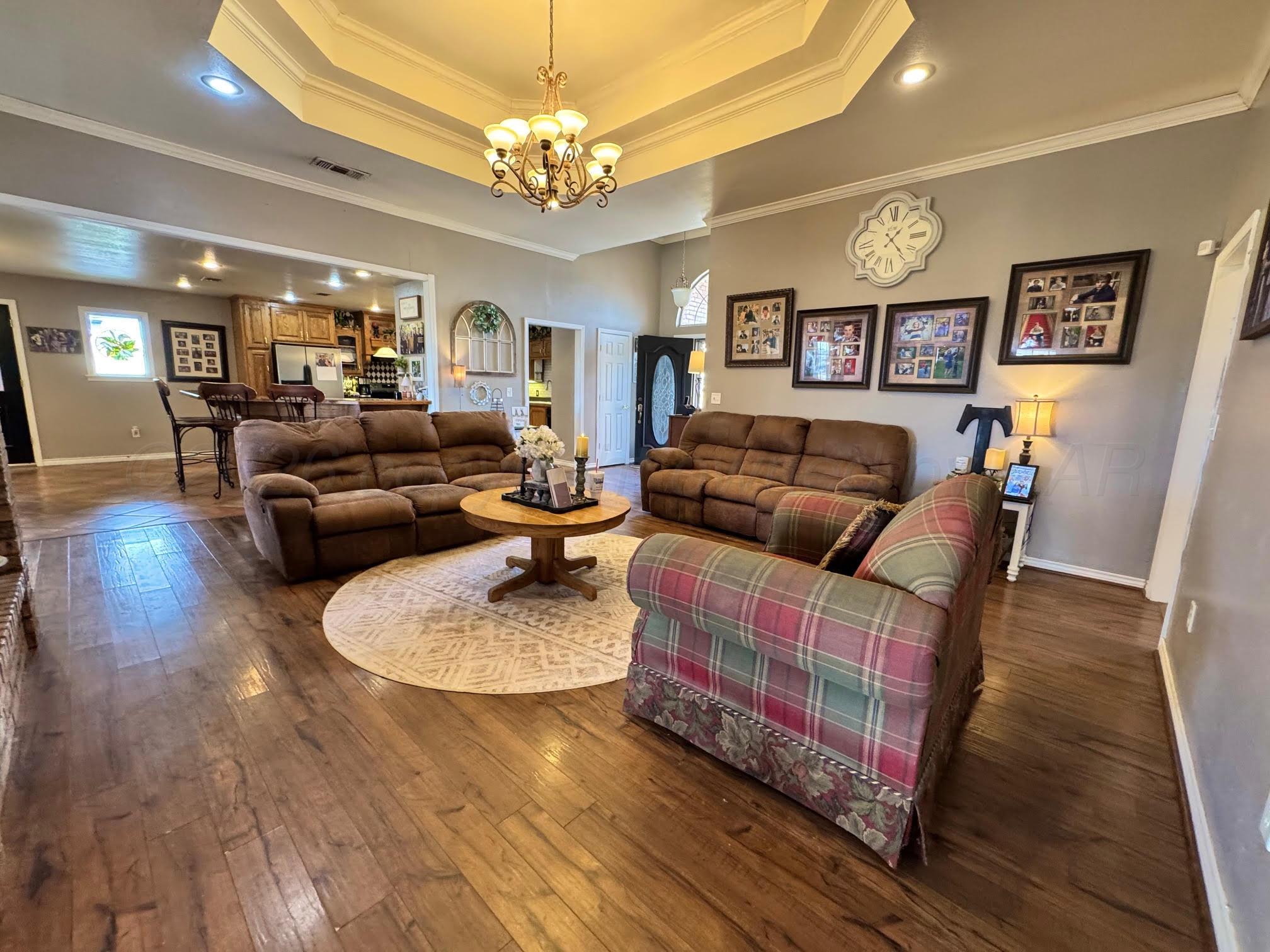 200 Hunters Trail Amarillo, TX 79124 - Photo 3 of 23 a living room with furniture and a chandelier