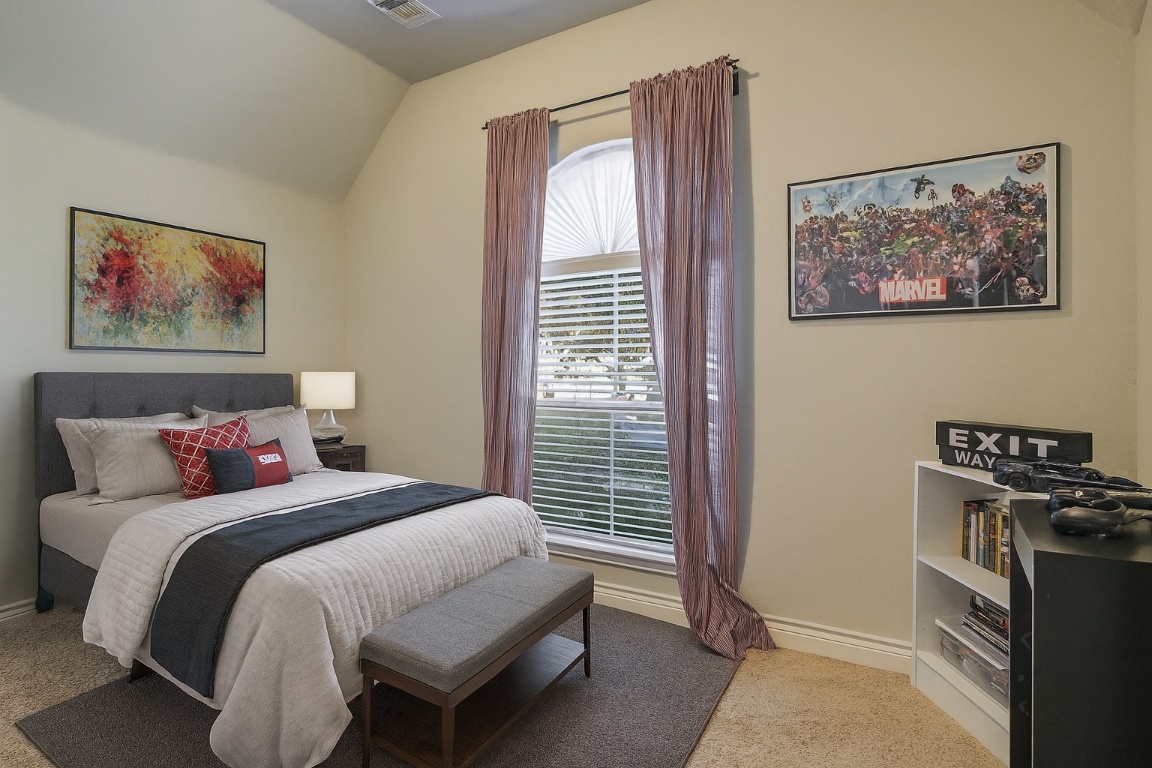 541 Cortona Lane Georgetown, TX 78628 - Photo 12 of 19 a bedroom with a bed and a painting on the wall