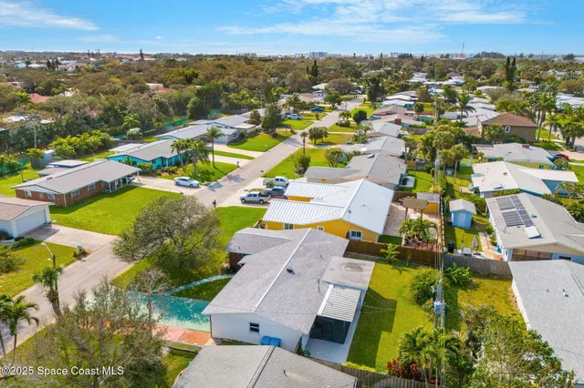 aerial view of a house with a yard