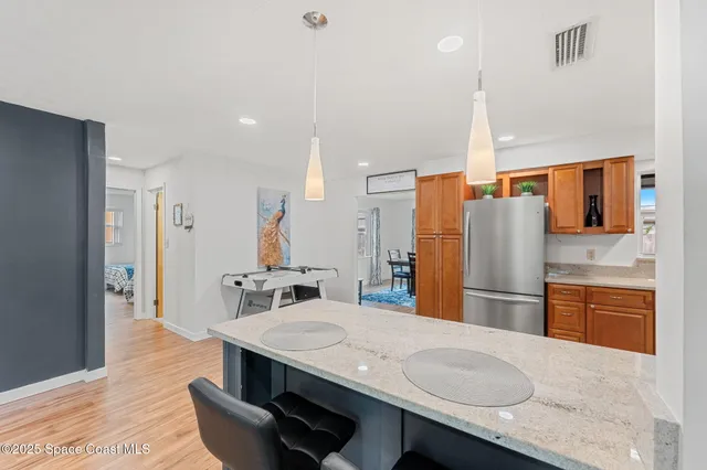 a kitchen with stainless steel appliances granite countertop a sink refrigerator and cabinets