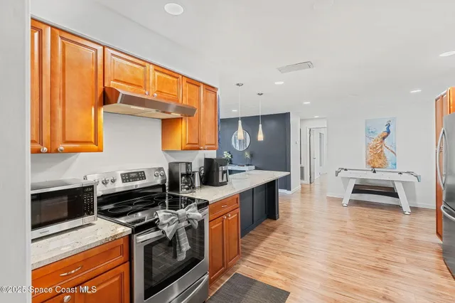 a kitchen with stainless steel appliances a stove a sink and a refrigerator
