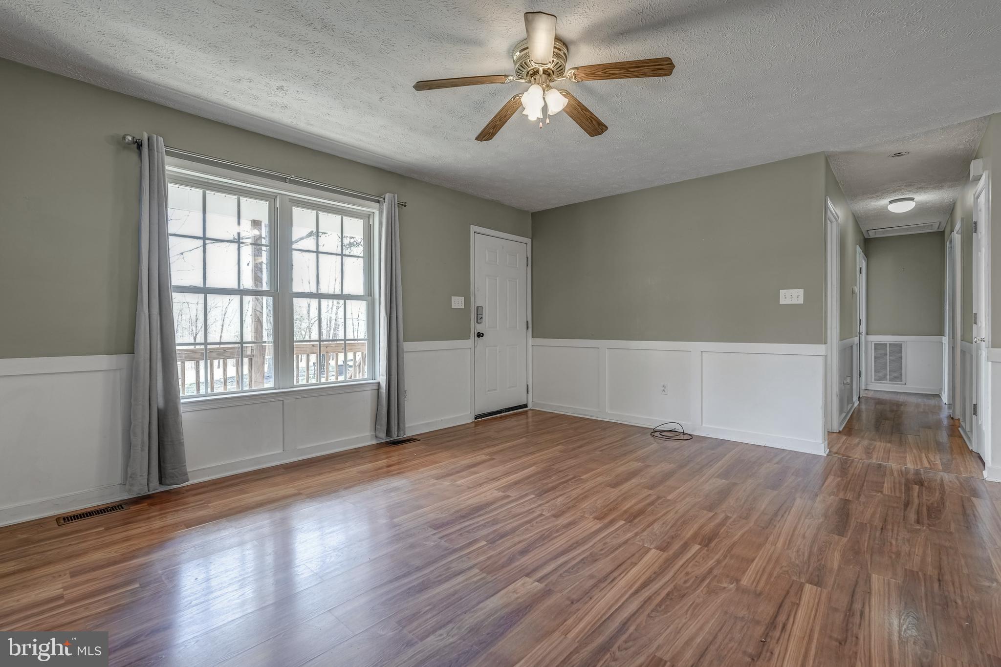 6021 Ridge Road Columbia, VA 23038 - Photo 23 of 40 a view of empty room with wooden floor and fan