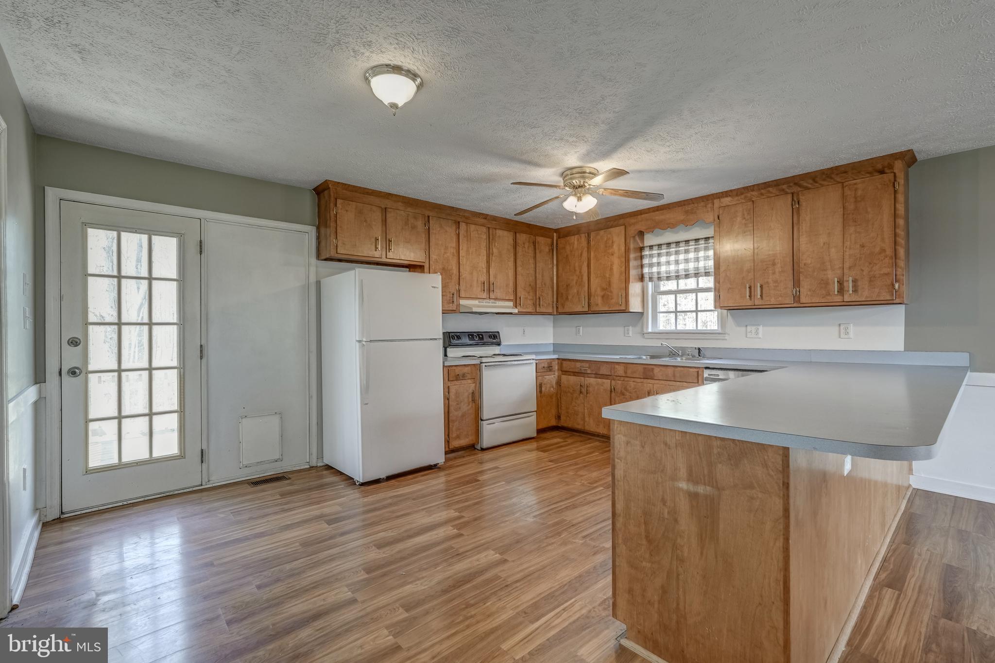 6021 Ridge Road Columbia, VA 23038 - Photo 25 of 40 a kitchen with a sink a center island cabinets and a window