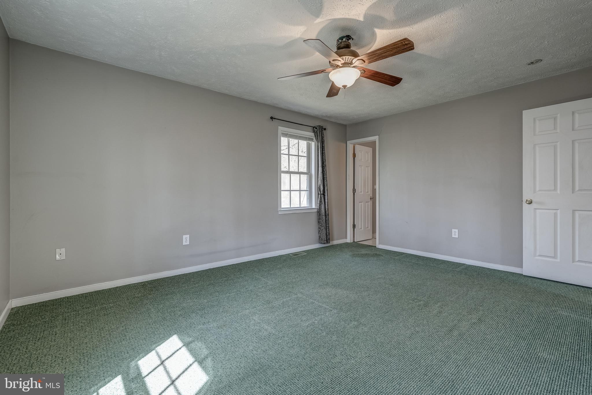 6021 Ridge Road Columbia, VA 23038 - Photo 39 of 40 an empty room with windows and fan