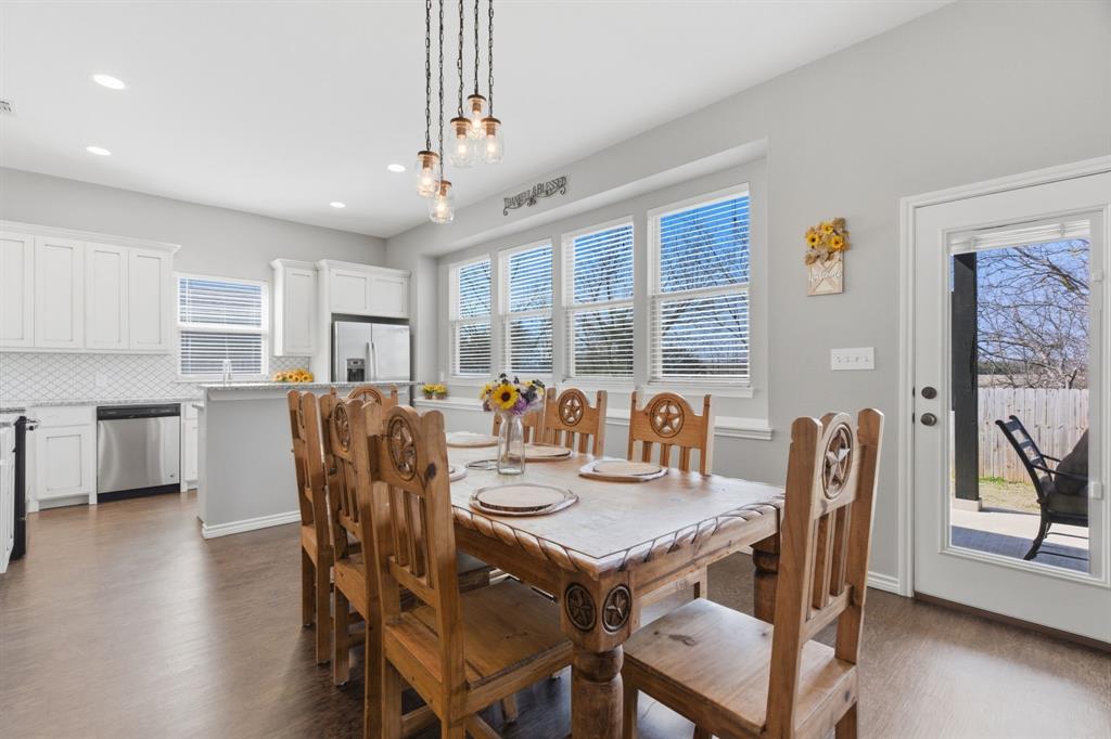 711 Hadley Lane Valley View, TX 76272 - Photo 5 of 40 Dining space with dark wood-style flooring and baseboards