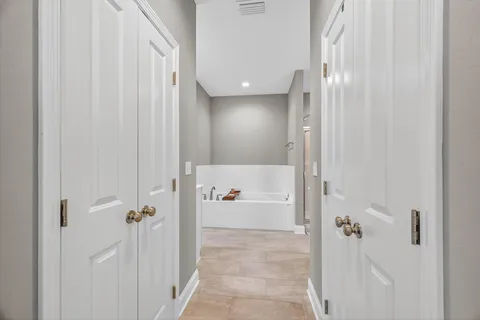 a kitchen with stainless steel appliances granite countertop a refrigerator oven a sink dishwasher and a dining table with wooden floor