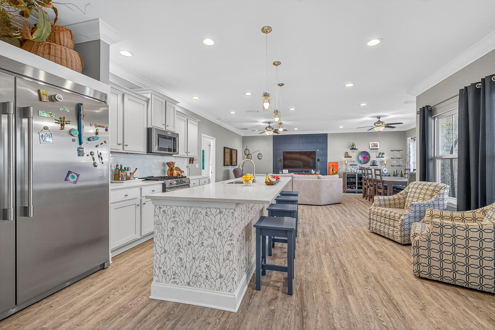 61 B 6th Street Shalimar, FL 32579 - Photo 33 of 59 a kitchen with stainless steel appliances granite countertop a refrigerator oven a sink dishwasher and a dining table with wooden floor