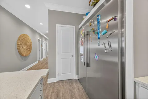 a living room with furniture a flat screen tv and kitchen view