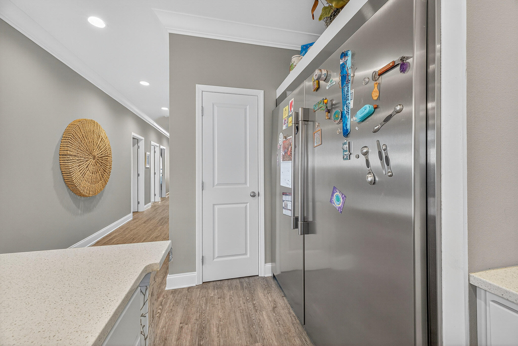 61 B 6th Street Shalimar, FL 32579 - Photo 41 of 59 a hallway with painting on the wall and wooden floor