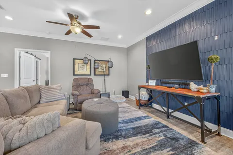 a bedroom with furniture and wooden floor