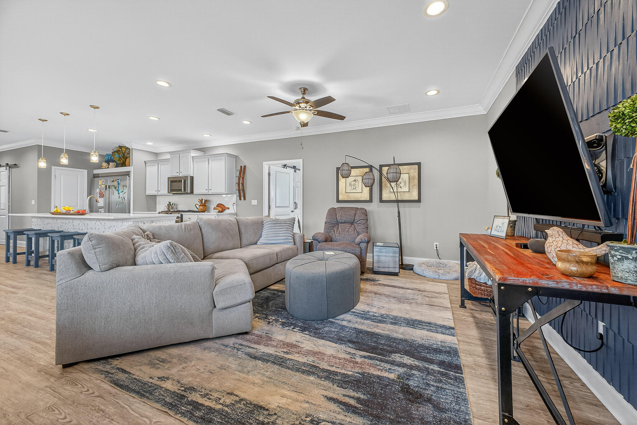 61 B 6th Street Shalimar, FL 32579 - Photo 48 of 59 a living room with furniture a flat screen tv and kitchen view