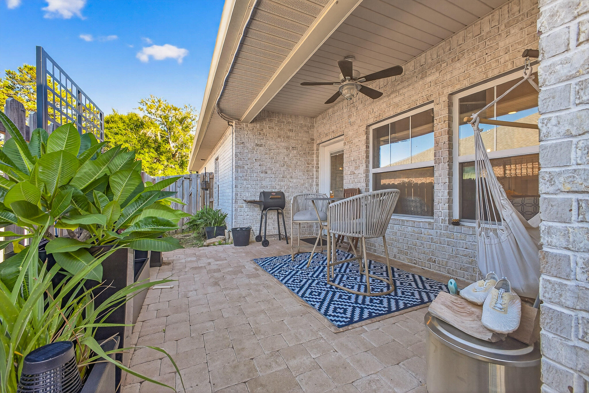 61 B 6th Street Shalimar, FL 32579 - Photo 58 of 59 a view of a patio with table and chairs potted plants with wooden floor and fence