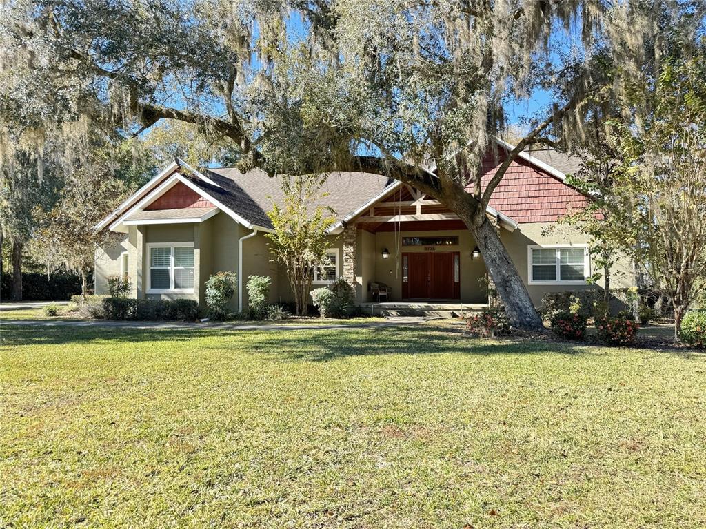 3108 North Wheaton Point Hernando, FL 34442 - Photo 35 of 35 a front view of a house with a garden and trees