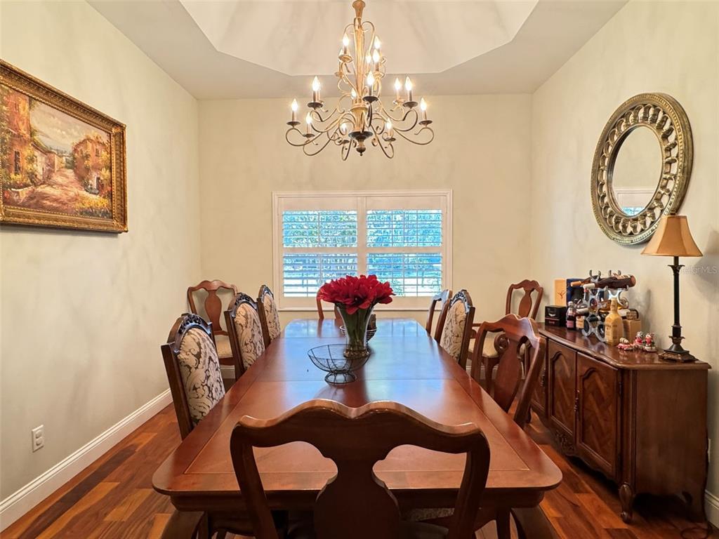 3108 North Wheaton Point Hernando, FL 34442 - Photo 7 of 35 a view of a dining room with furniture a chandelier and wooden floor