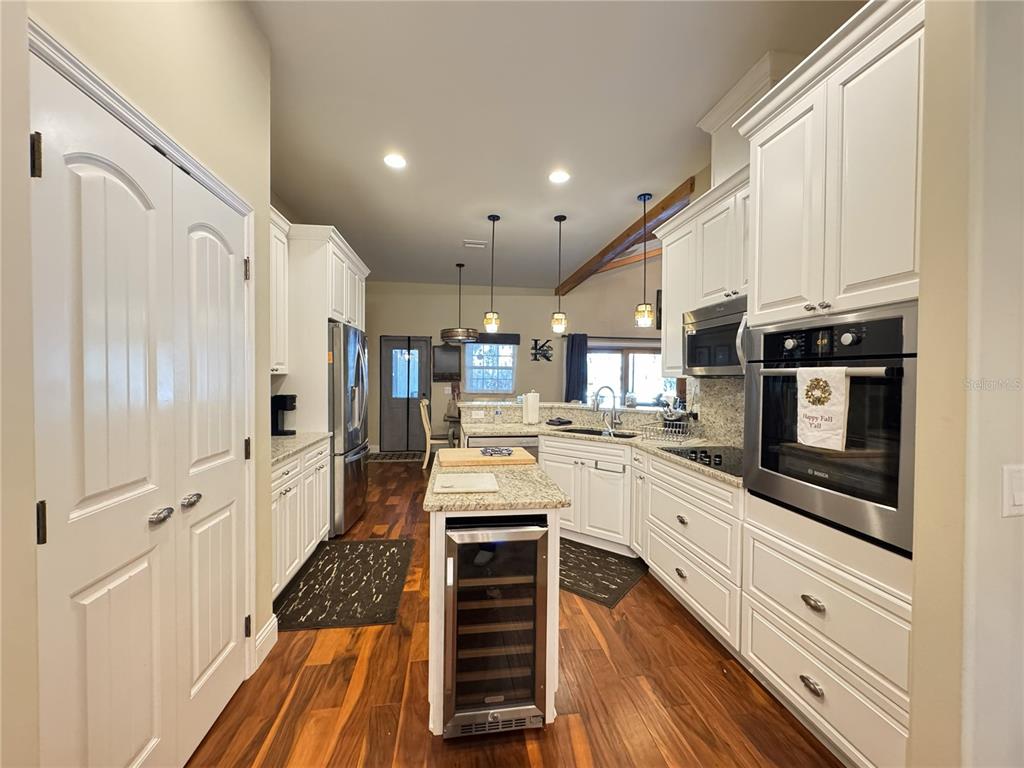 3108 North Wheaton Point Hernando, FL 34442 - Photo 9 of 35 a kitchen with stainless steel appliances kitchen island granite countertop a refrigerator and a stove top oven