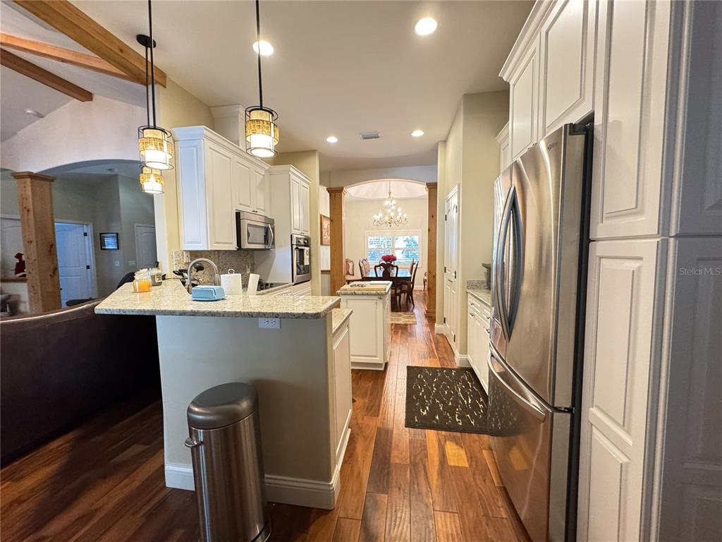 3108 North Wheaton Point Hernando, FL 34442 - Photo 10 of 35 a kitchen with kitchen island white cabinets and stainless steel appliances