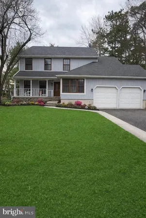 a front view of house with yard barbeque and outdoor seating