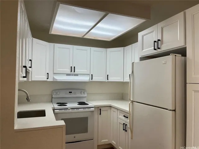 a white refrigerator freezer sitting in a kitchen