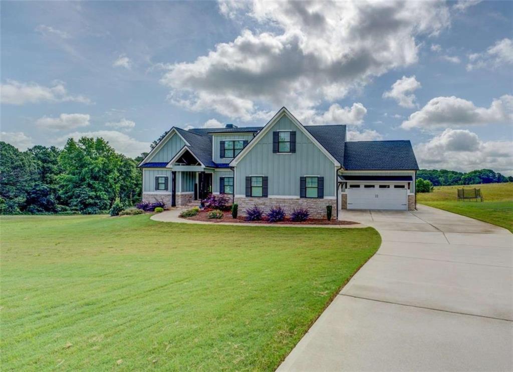 a front view of house with yard and green space