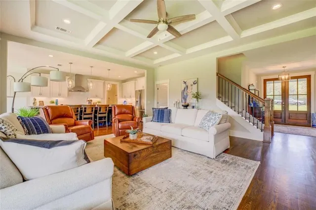 a living room with furniture and wooden floor