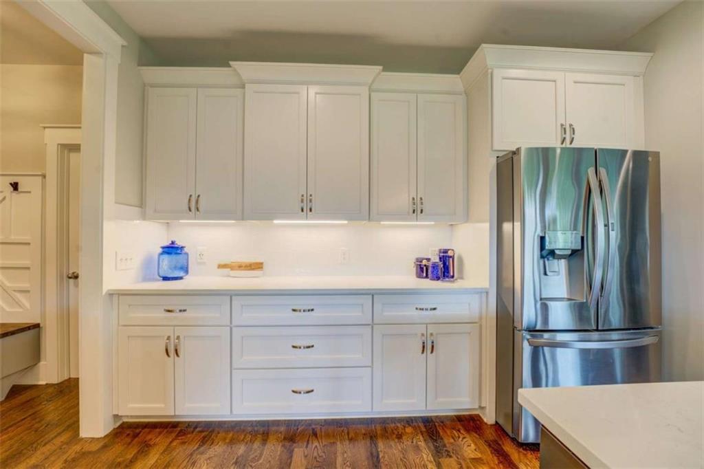 3076 East Lake Road McDonough, GA 30252 - Photo 15 of 49 a kitchen with white cabinets and refrigerator