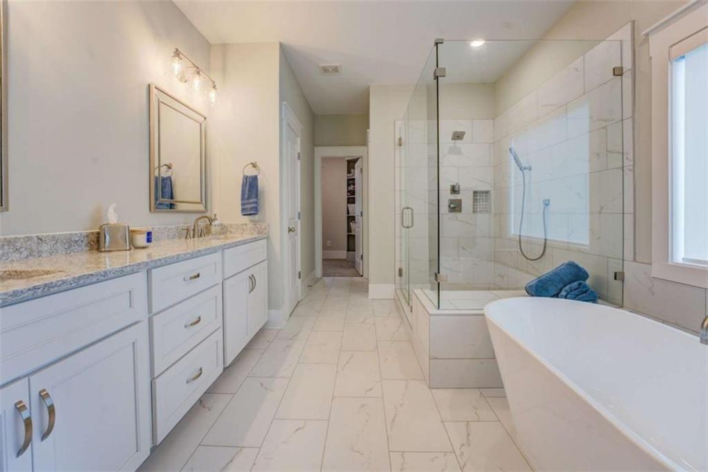 3076 East Lake Road McDonough, GA 30252 - Photo 25 of 49 a spacious bathroom with a bathtub shower and sink