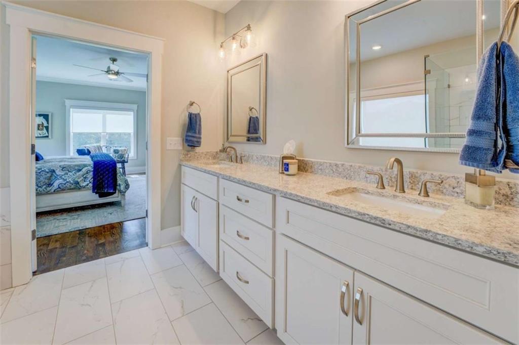 3076 East Lake Road McDonough, GA 30252 - Photo 26 of 49 a en suite bathroom with double sink and a mirror