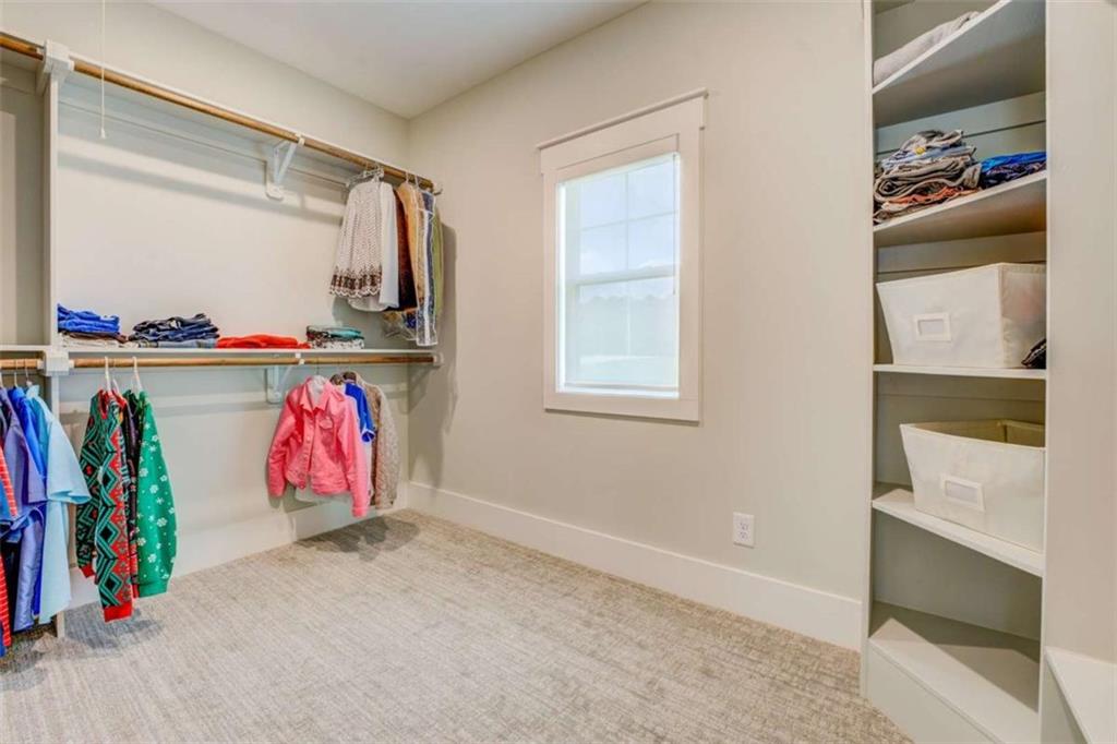 3076 East Lake Road McDonough, GA 30252 - Photo 29 of 49 a view of walk in closet with clothes and shoes