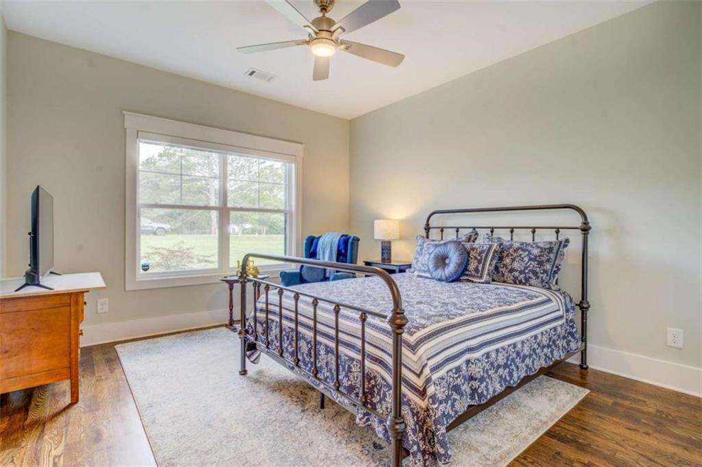 3076 East Lake Road McDonough, GA 30252 - Photo 30 of 49 a bedroom with a bed and a large window