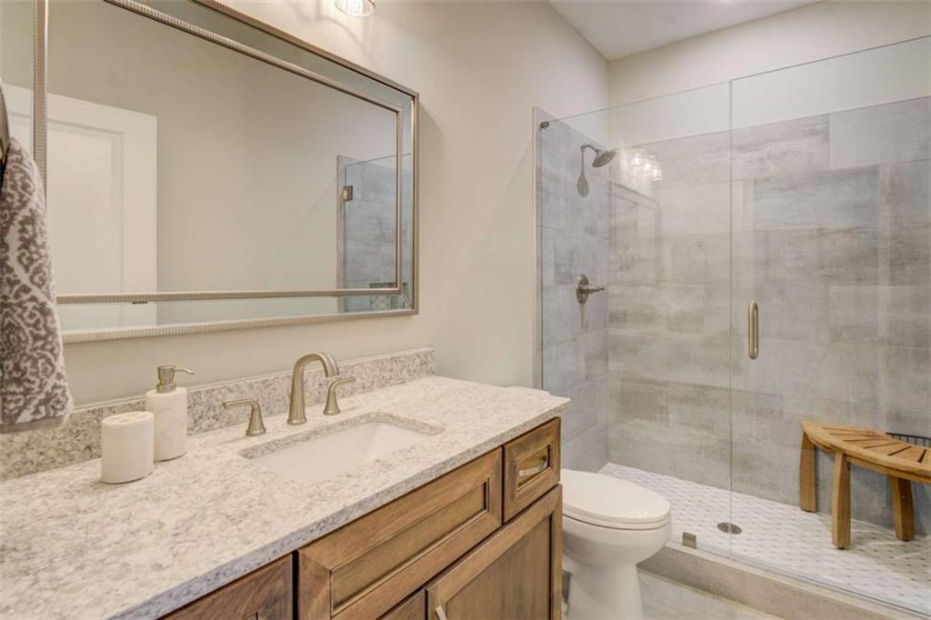 3076 East Lake Road McDonough, GA 30252 - Photo 31 of 49 a bathroom with a sink a toilet and shower