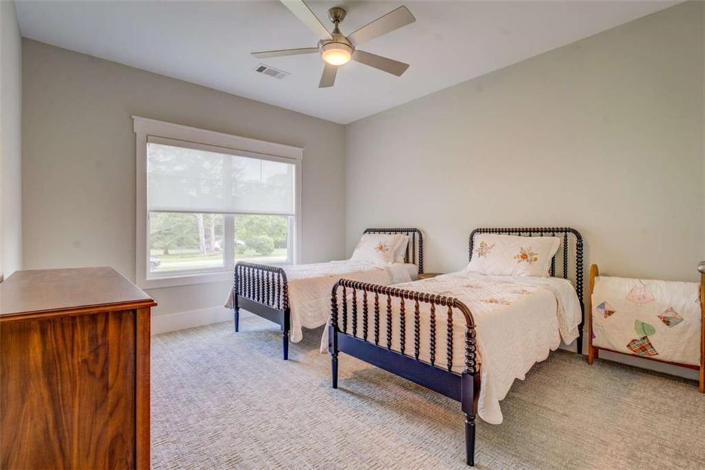 3076 East Lake Road McDonough, GA 30252 - Photo 34 of 49 a bedroom with two beds and a chandelier