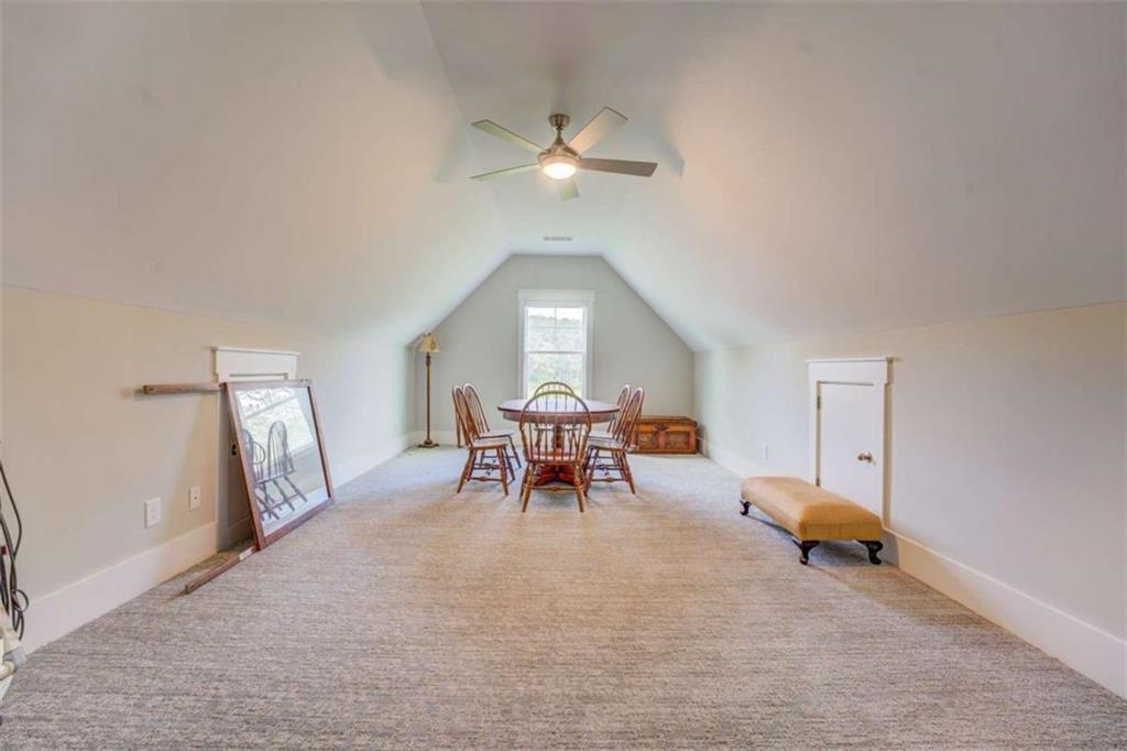 3076 East Lake Road McDonough, GA 30252 - Photo 35 of 49 a living room with furniture and a chandelier