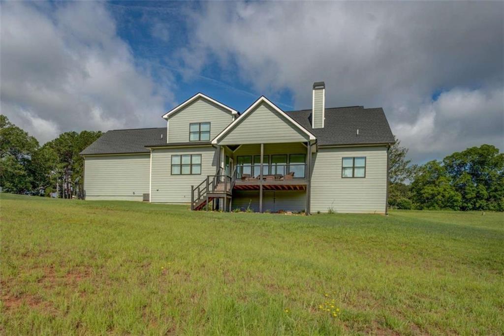 3076 East Lake Road McDonough, GA 30252 - Photo 45 of 49 a front view of a house with a garden and yard