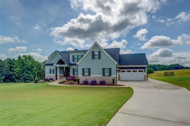 a front view of house with yard and green space