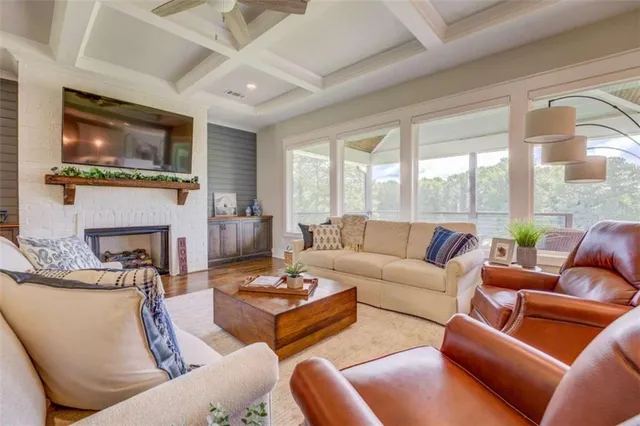 a living room with fireplace furniture and a flat screen tv