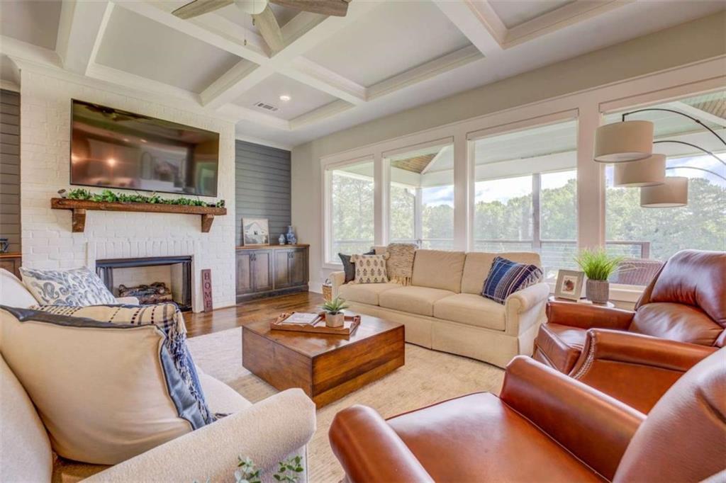 3076 East Lake Road McDonough, GA 30252 - Photo 8 of 49 a living room with fireplace furniture and a flat screen tv