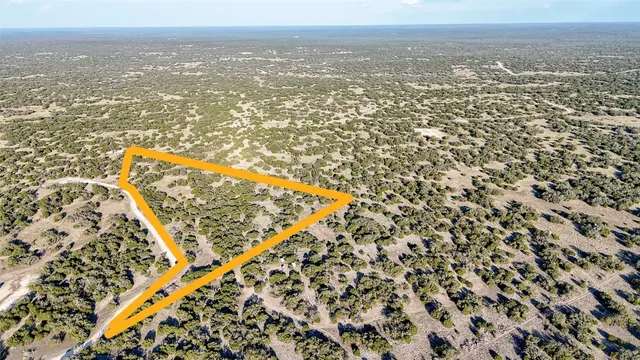 an aerial view of residential building with yard