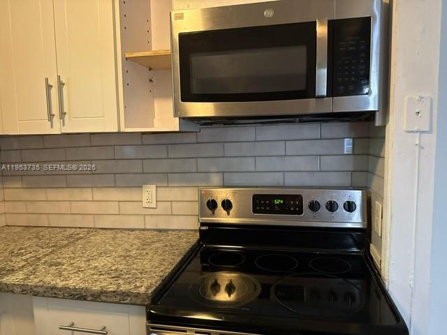 90 Northeast 68th Street, Unit 90 Miami, FL 33138 - Photo 3 of 5 a bathroom with a stove and a microwave
