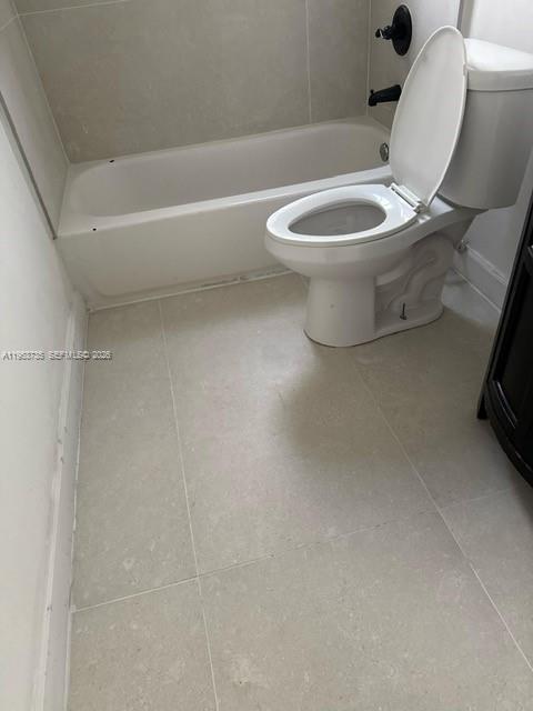 90 Northeast 68th Street, Unit 90 Miami, FL 33138 - Photo 5 of 5 a white toilet sitting next to a bath tub