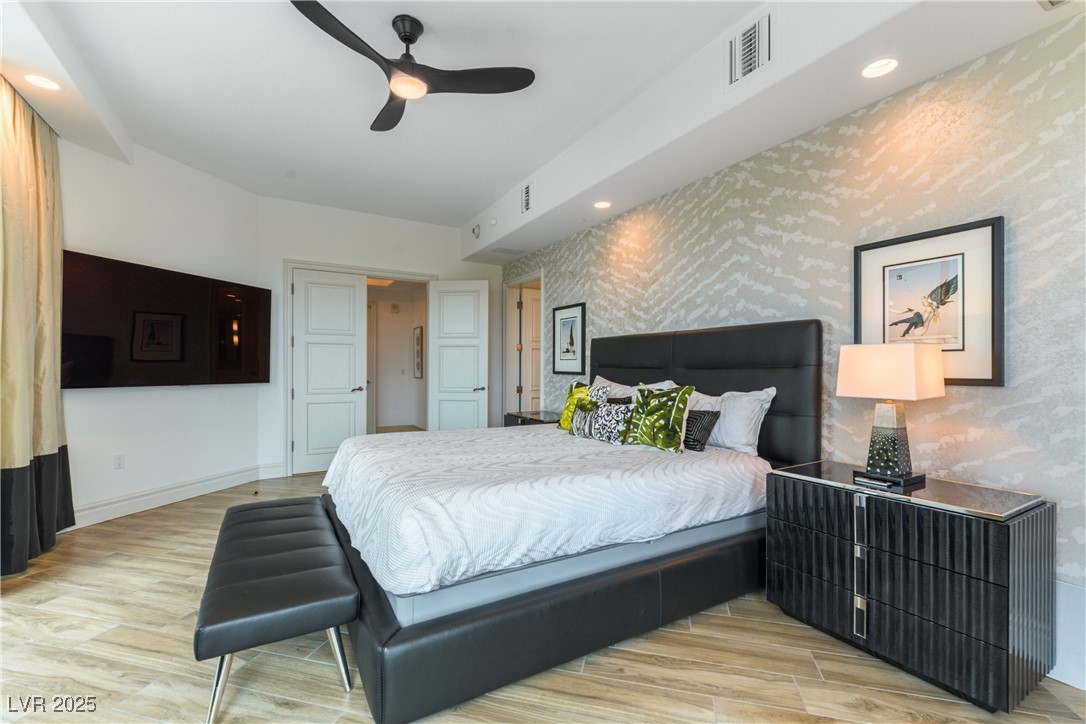 9101 Alta Drive, Unit 505 Las Vegas, NV 89145 - Photo 24 of 64 Bedroom with light wood finished floors, recessed lighting, ceiling fan, and wallpapered walls